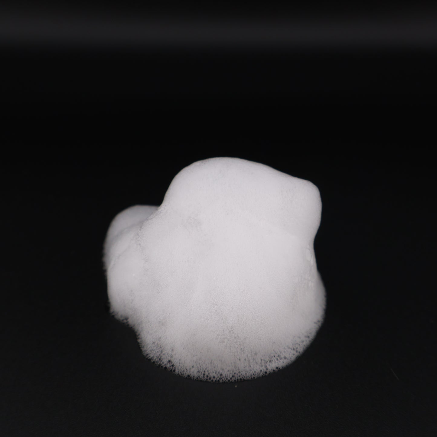 Mr Wrinkles Sphynx Sphynx Waterless Cleansing Foam close up of the the white foam on a black surface