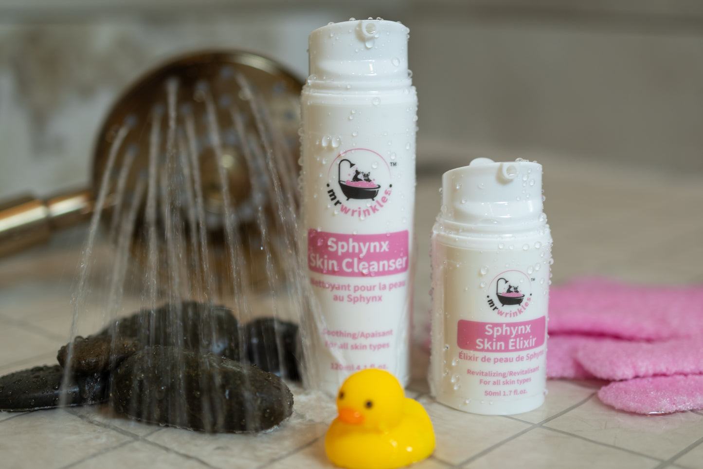 Mr Wrinkles hairless cat skin care duo products in a shower with spray wand and yellow rubber ducky